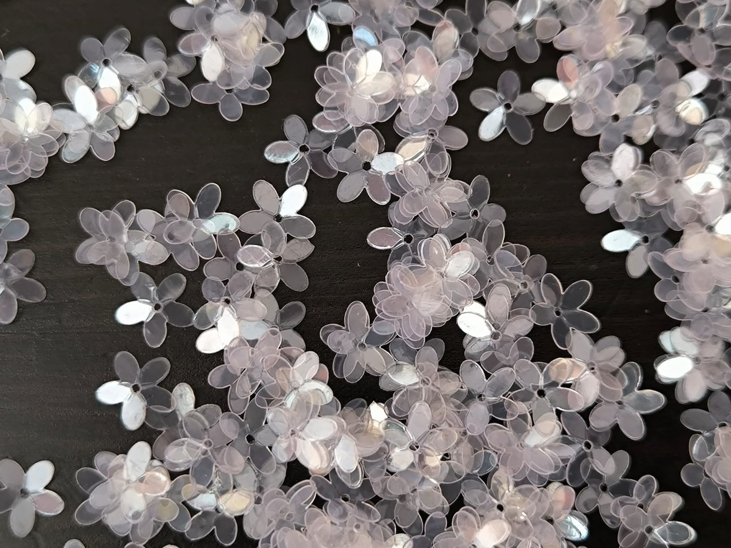 Paillettes petites fleurs transparentes reflet rose 9 mm