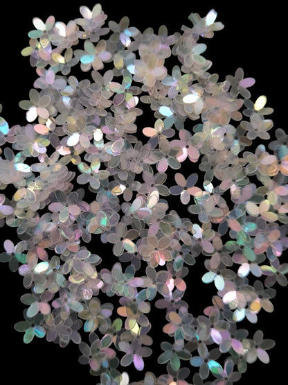 Paillettes petites fleurs blanc transparent  irisé bleu rose 9 mm