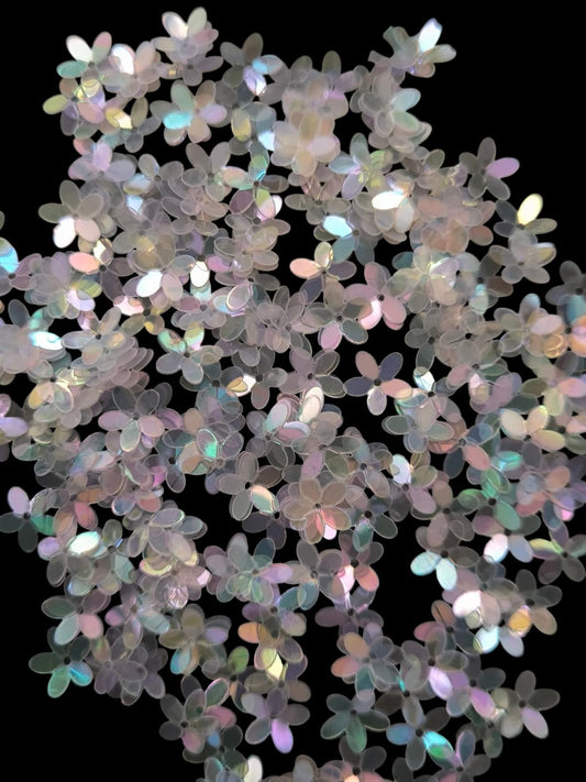 Paillettes petites fleurs blanc transparent  irisé bleu rose 9 mm
